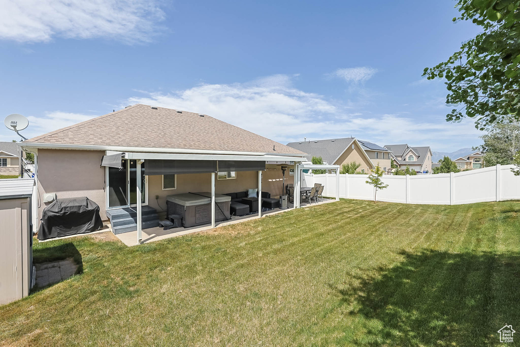 Rear view of house with a fenced backyard, entry steps, stucco siding, a patio, and a residential view