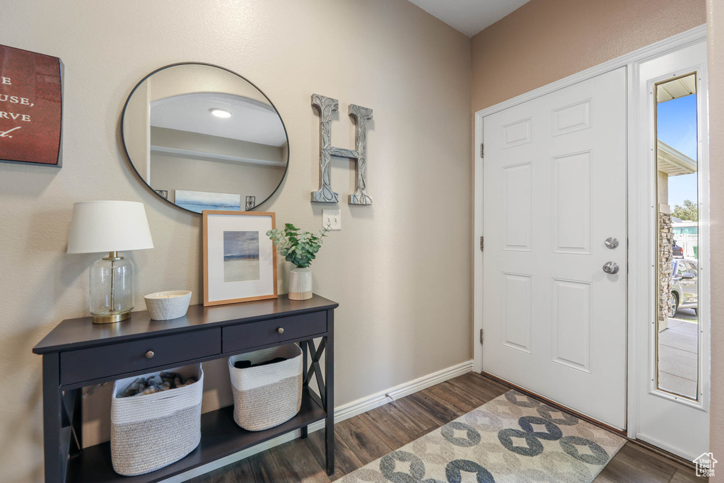 Entryway featuring wood finished floors and baseboards