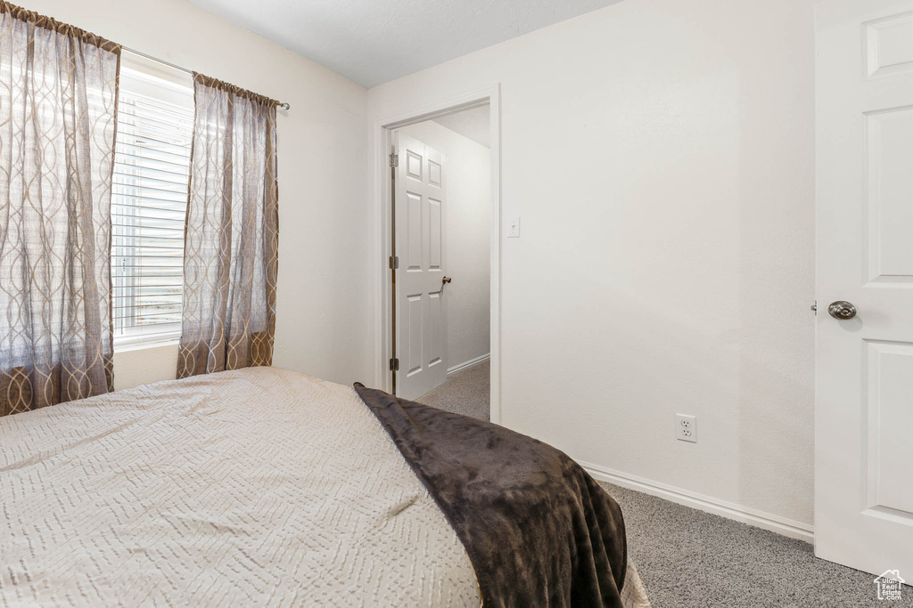 Carpeted bedroom featuring baseboards