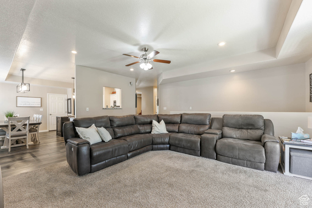 Living room with a ceiling fan, dark wood-style flooring, and recessed lighting