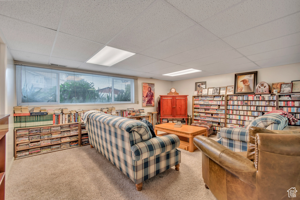 Carpeted living area with a drop ceiling