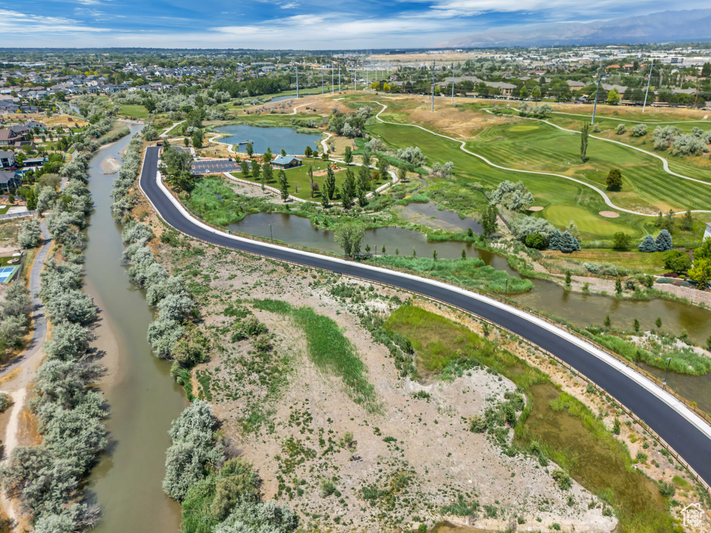 View of property location featuring a nearby body of water and a golf course