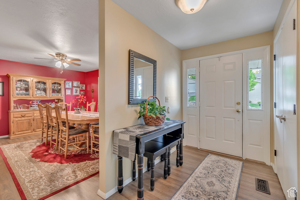 Foyer featuring light wood finished floors and ceiling fan