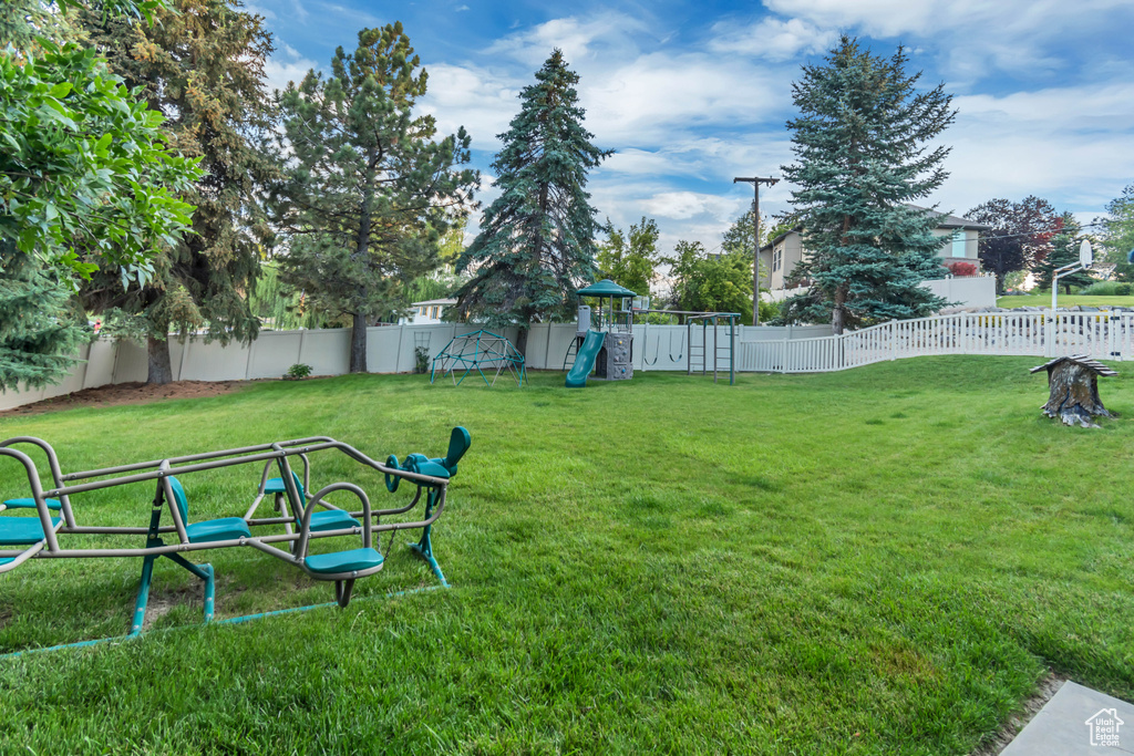 Fenced backyard with a playground
