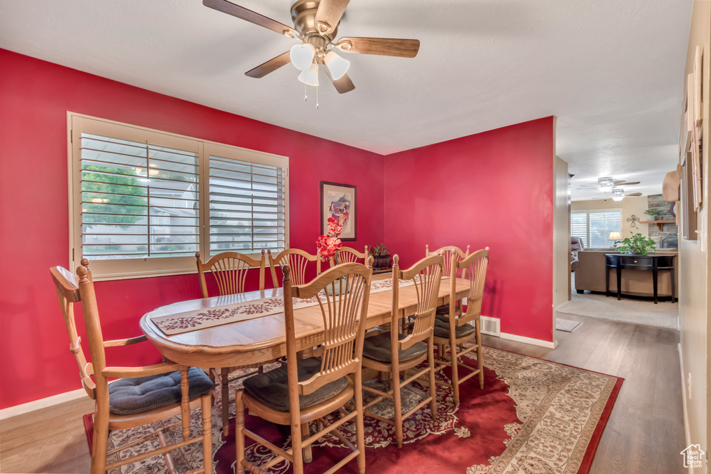 Dining area featuring a ceiling fan and wood finished floors