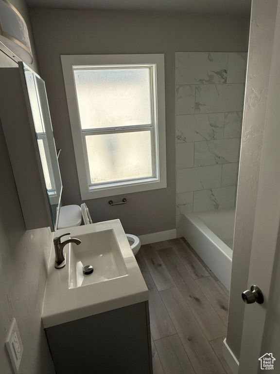 Full bath featuring vanity and wood finished floors