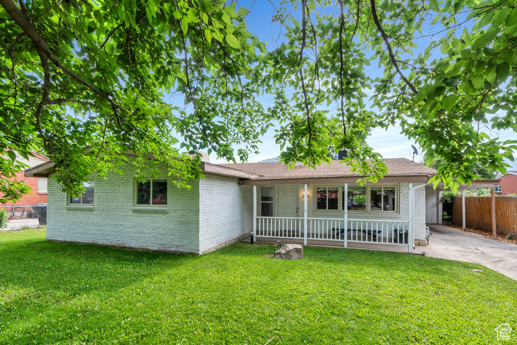 Ranch-style home with a porch, brick siding, and driveway