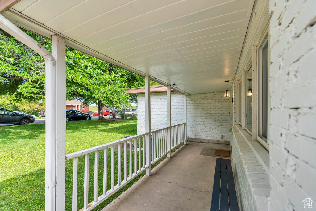 Covered porch with a lawn