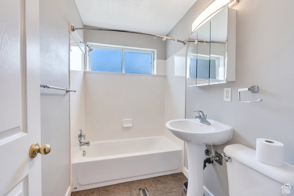 Bathroom with bathtub / shower combination and tile patterned flooring