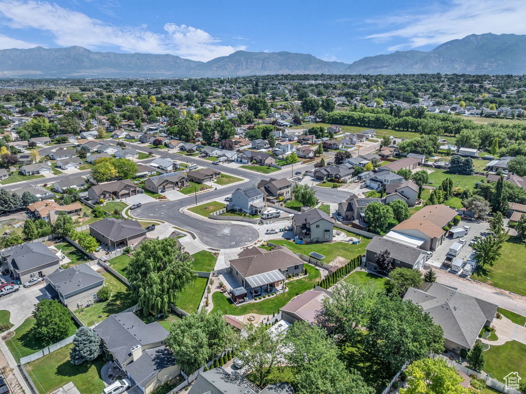 Aerial view of residential area featuring a mountainous background