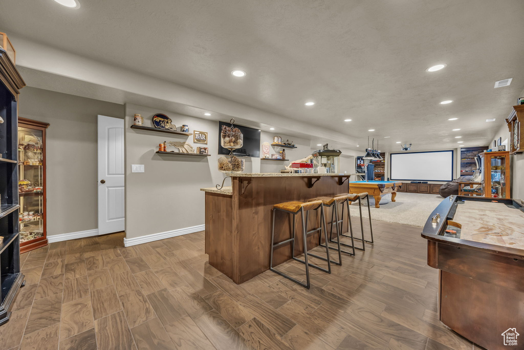 Indoor bar featuring recessed lighting, dark wood-style flooring, and pool table