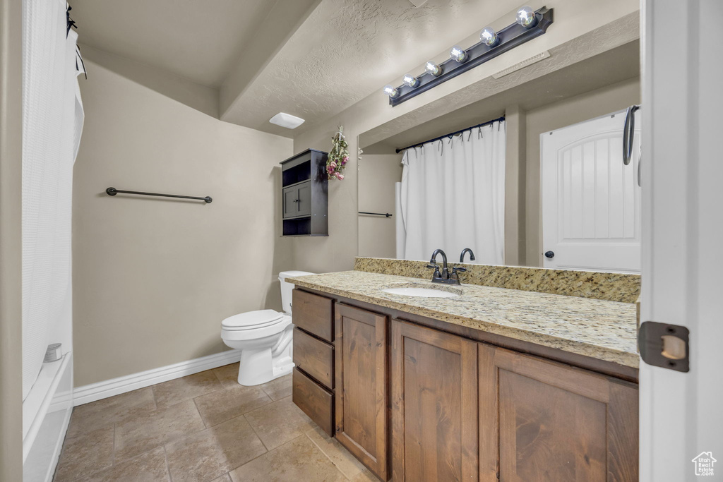 Full bathroom with vanity and stone finish flooring