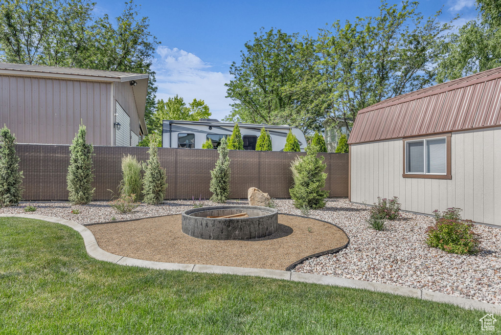 Fenced backyard featuring a fire pit