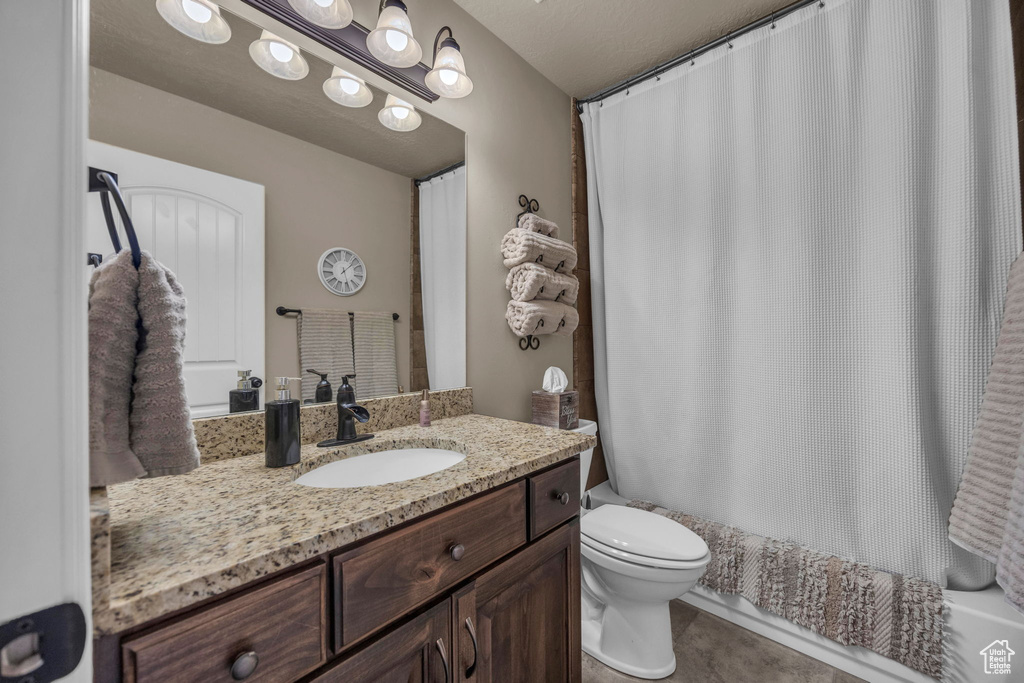 Bathroom with vanity and shower / bath combination with curtain