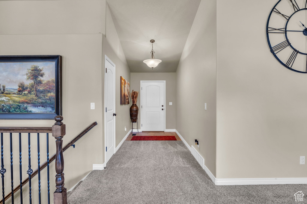 Doorway with carpet and baseboards