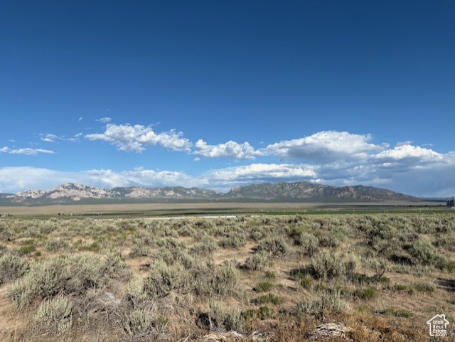View of mountain backdrop featuring rural landscape