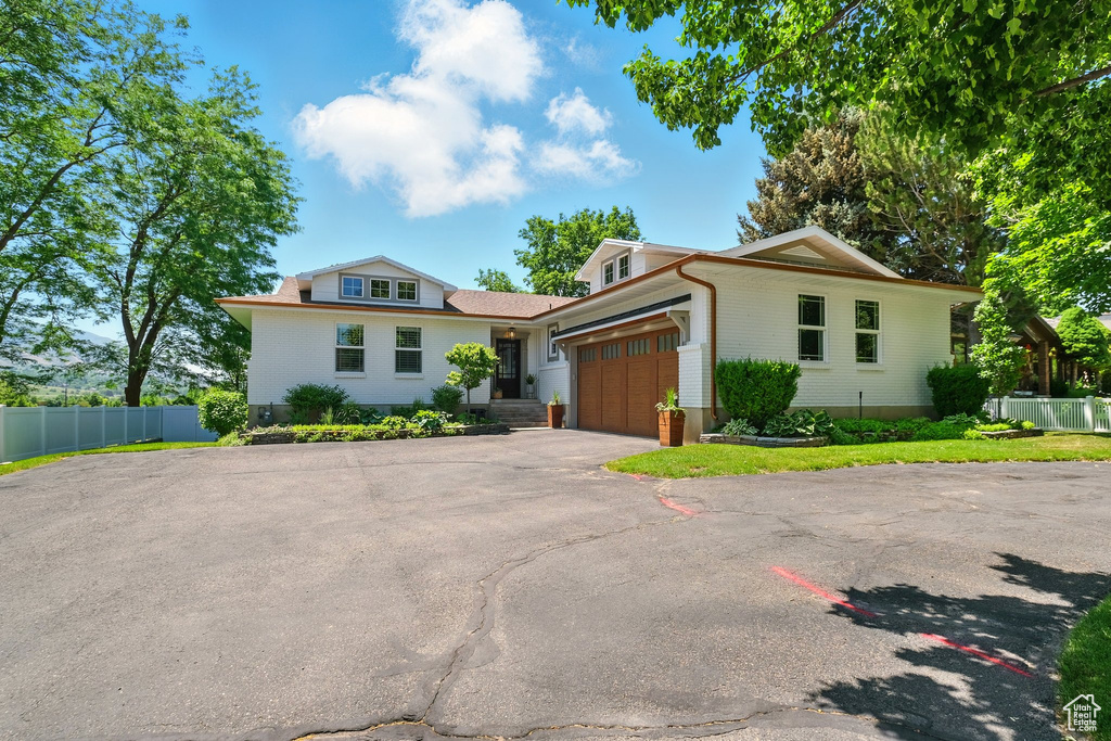 View of front of house with a garage and driveway