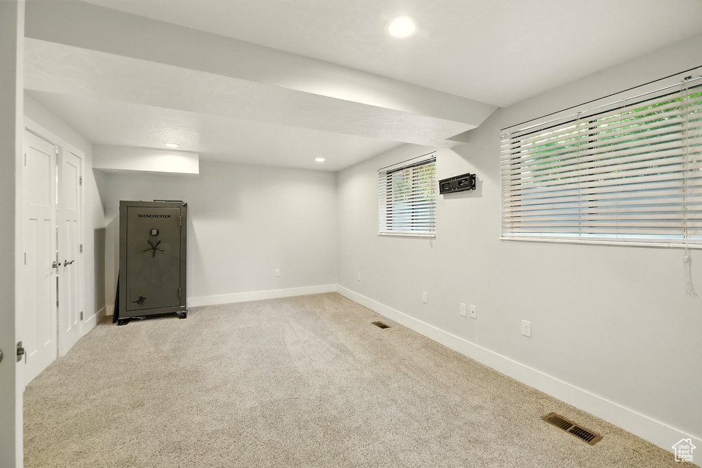 Basement with recessed lighting and light colored carpet