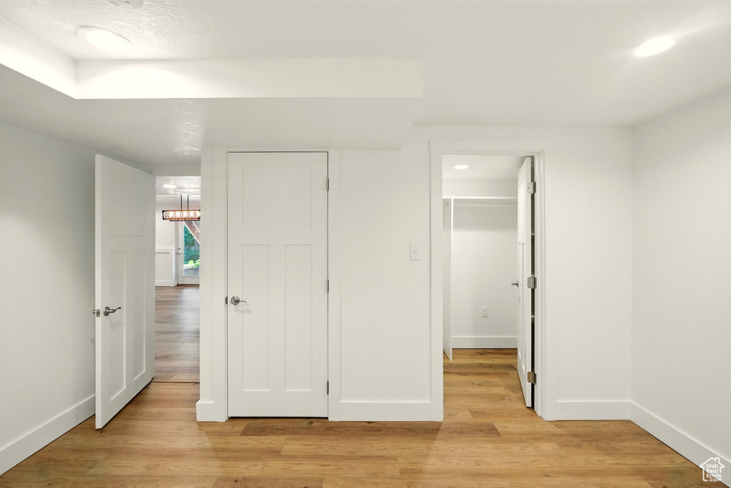 Unfurnished bedroom with light wood finished floors, a closet, and a walk in closet