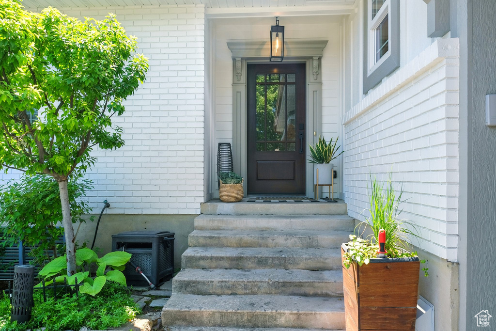 Entrance to property featuring brick siding