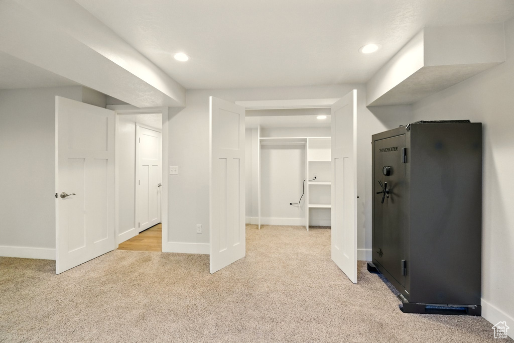 Unfurnished bedroom with light carpet, recessed lighting, and a spacious closet