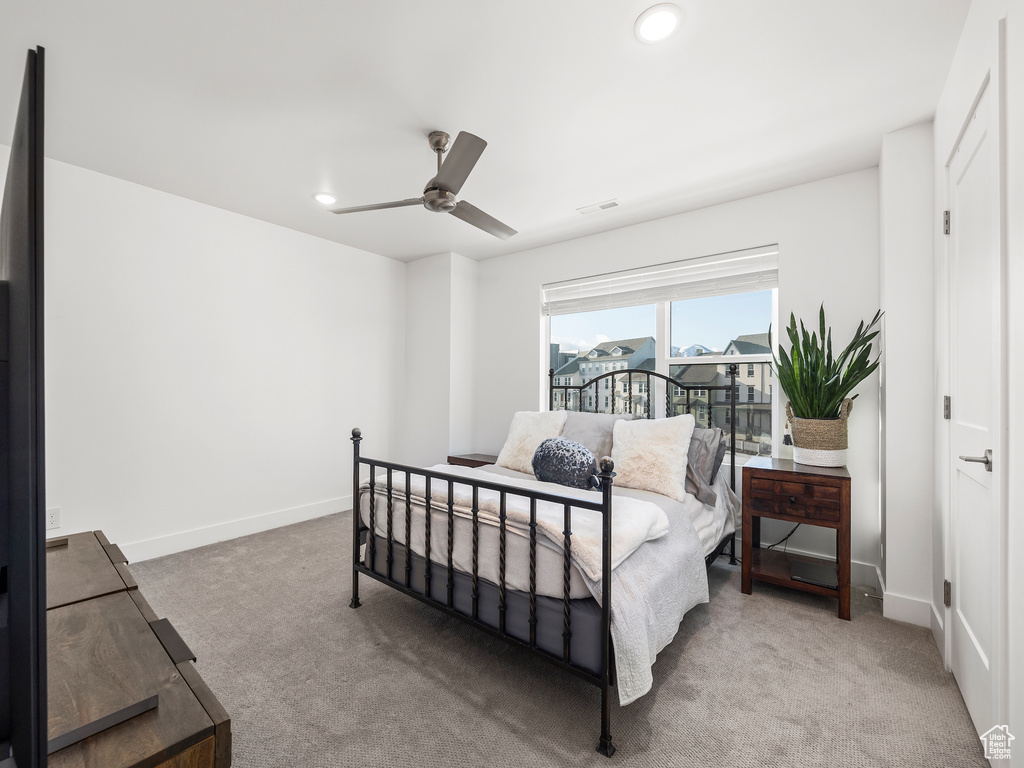 Carpeted bedroom featuring recessed lighting and a ceiling fan