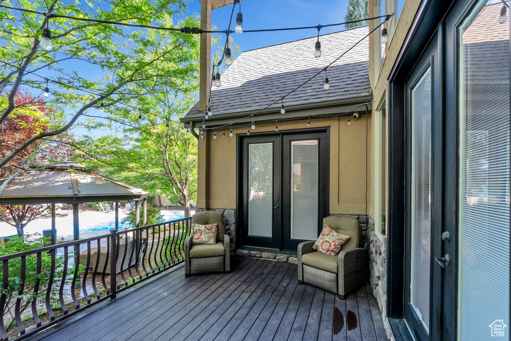 Wooden deck featuring french doors and a gazebo