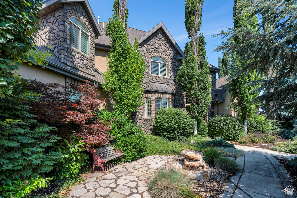 View of front of property with stone siding and stucco siding