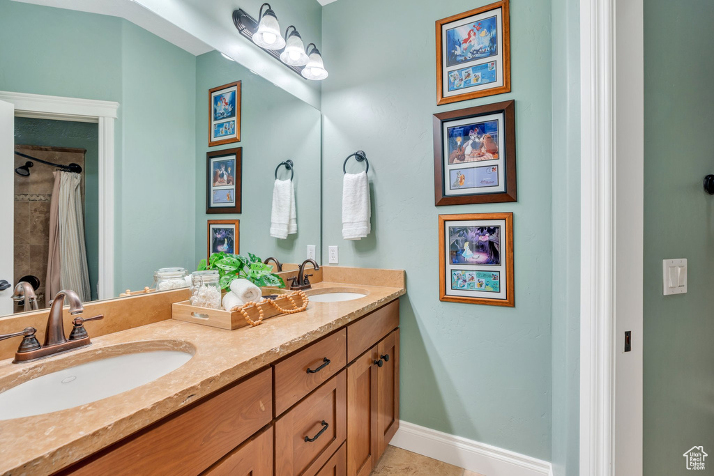 Full bath featuring double vanity and a shower with shower curtain