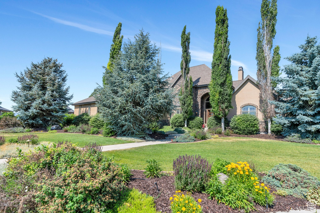 View of front of house with a front yard and a chimney