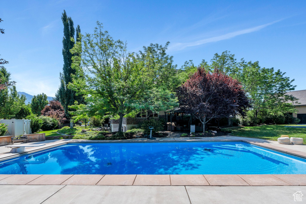 Outdoor pool featuring a gazebo and a mountain view