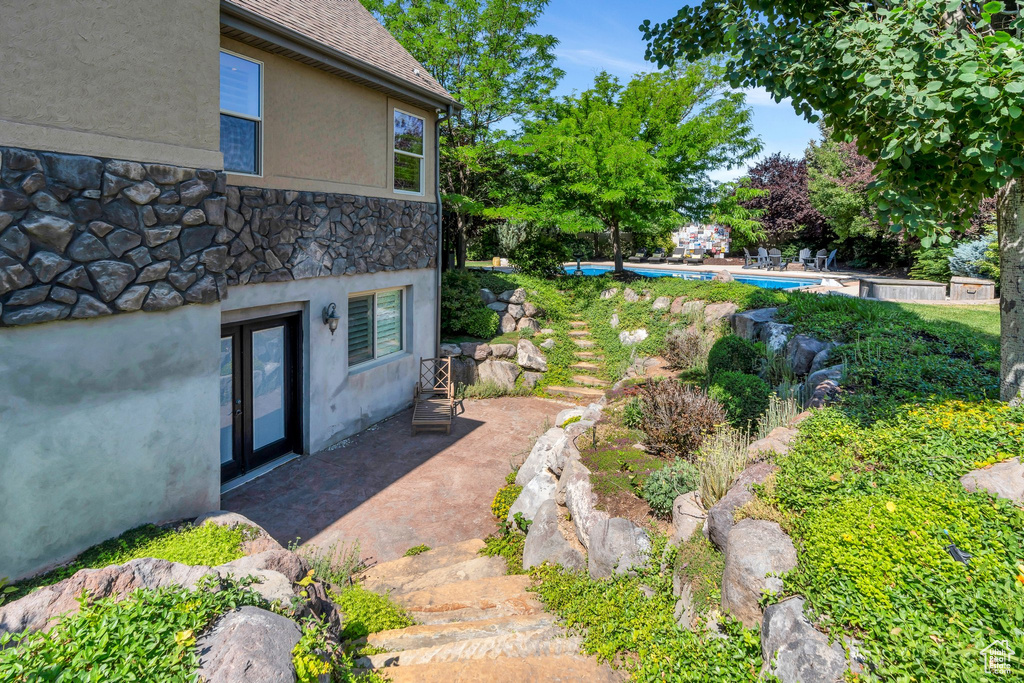 View of yard with an outdoor pool and a patio
