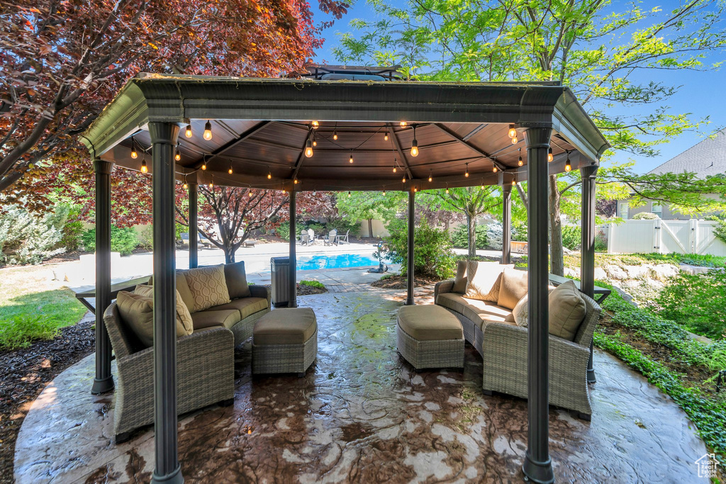 Fenced backyard with a gazebo, an outdoor living space, and a patio