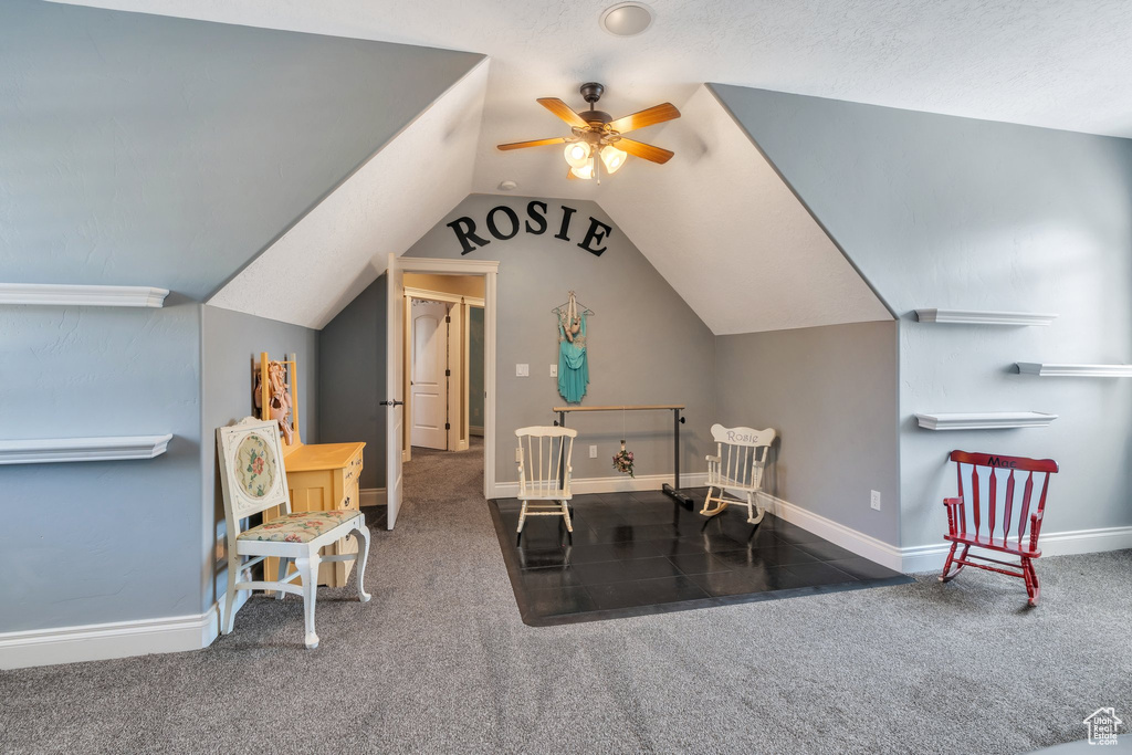 Office area with ceiling fan, carpet, and lofted ceiling