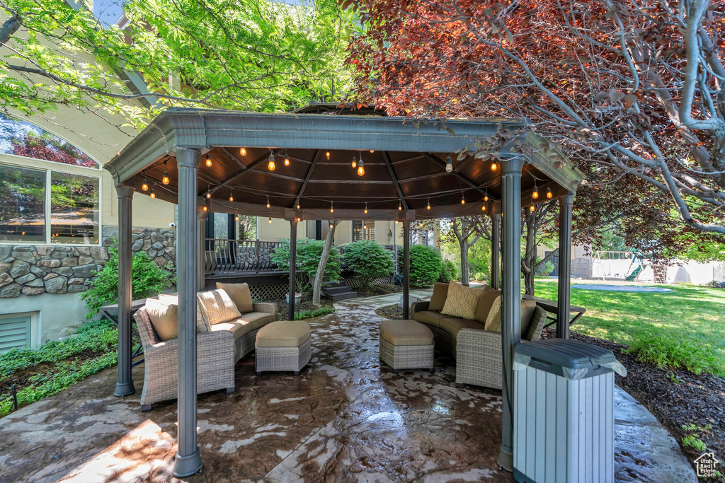 View of patio featuring outdoor lounge area and a gazebo