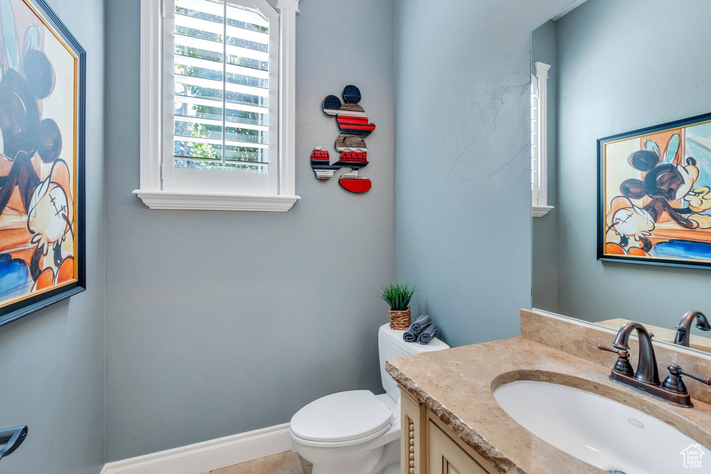 Half bathroom featuring toilet and vanity