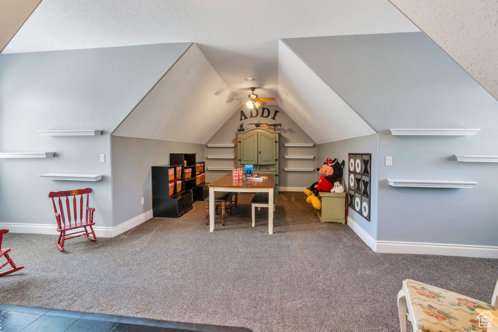Playroom with carpet flooring, vaulted ceiling, and ceiling fan