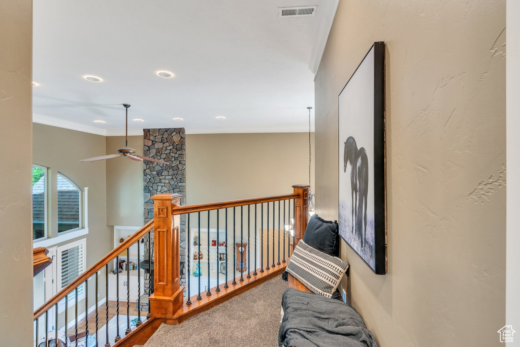 Corridor featuring ornamental molding, recessed lighting, and an upstairs landing