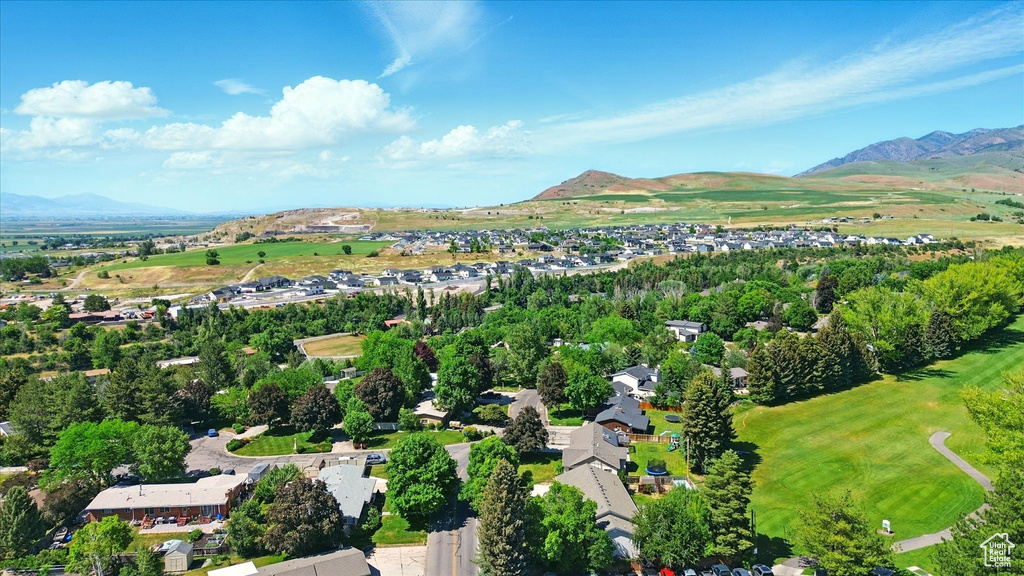 Aerial view of property\'s location with a mountainous background and nearby suburban area