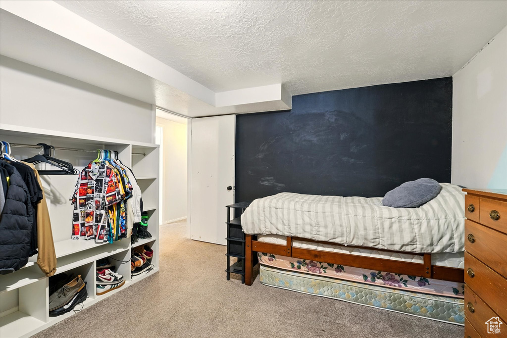 Carpeted bedroom with a textured ceiling