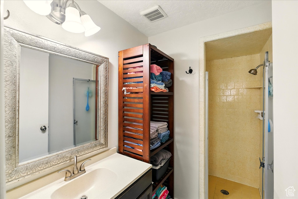 Bathroom with a stall shower and vanity
