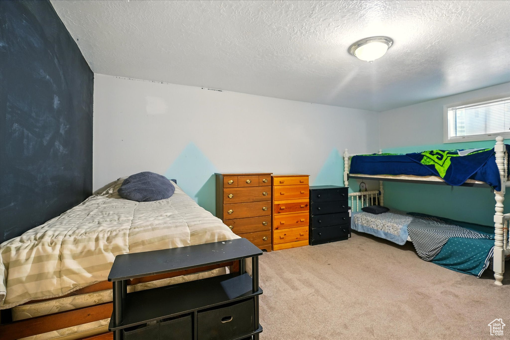 Carpeted bedroom with a textured ceiling