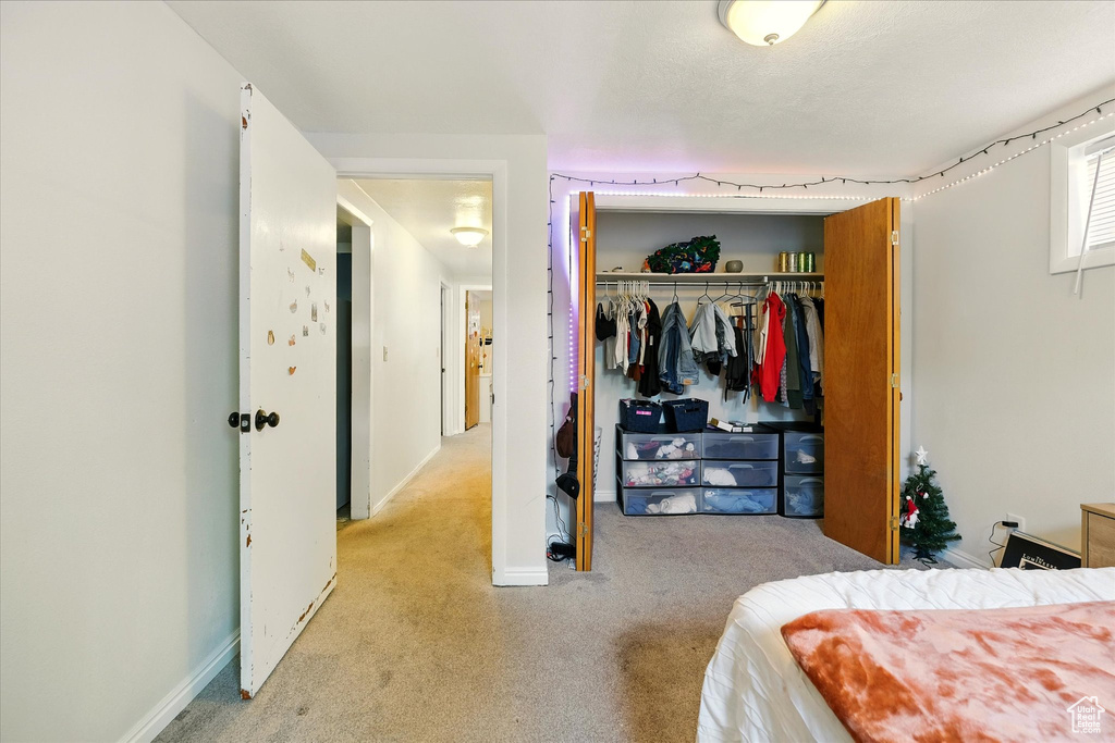 Bedroom with carpet flooring and a closet