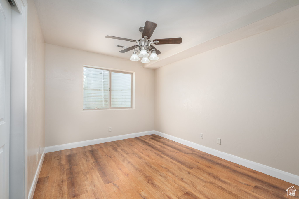 Spare room featuring light wood-style floors and a ceiling fan