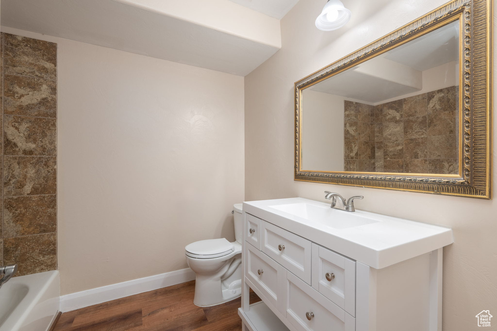 Full bathroom with wood finished floors and vanity