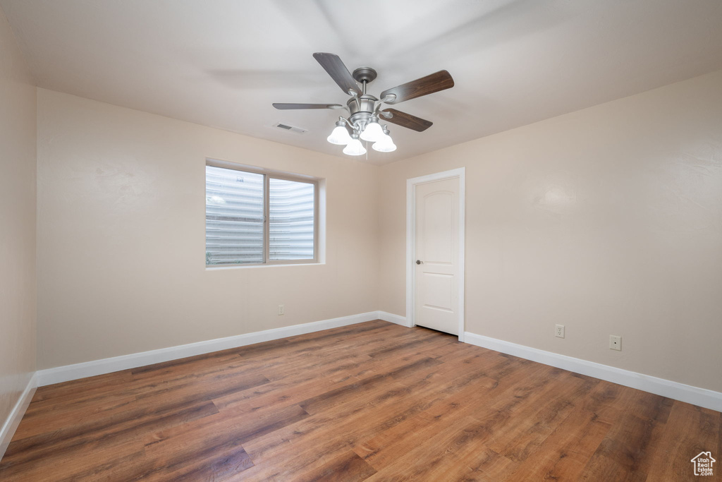 Empty room with ceiling fan and wood finished floors