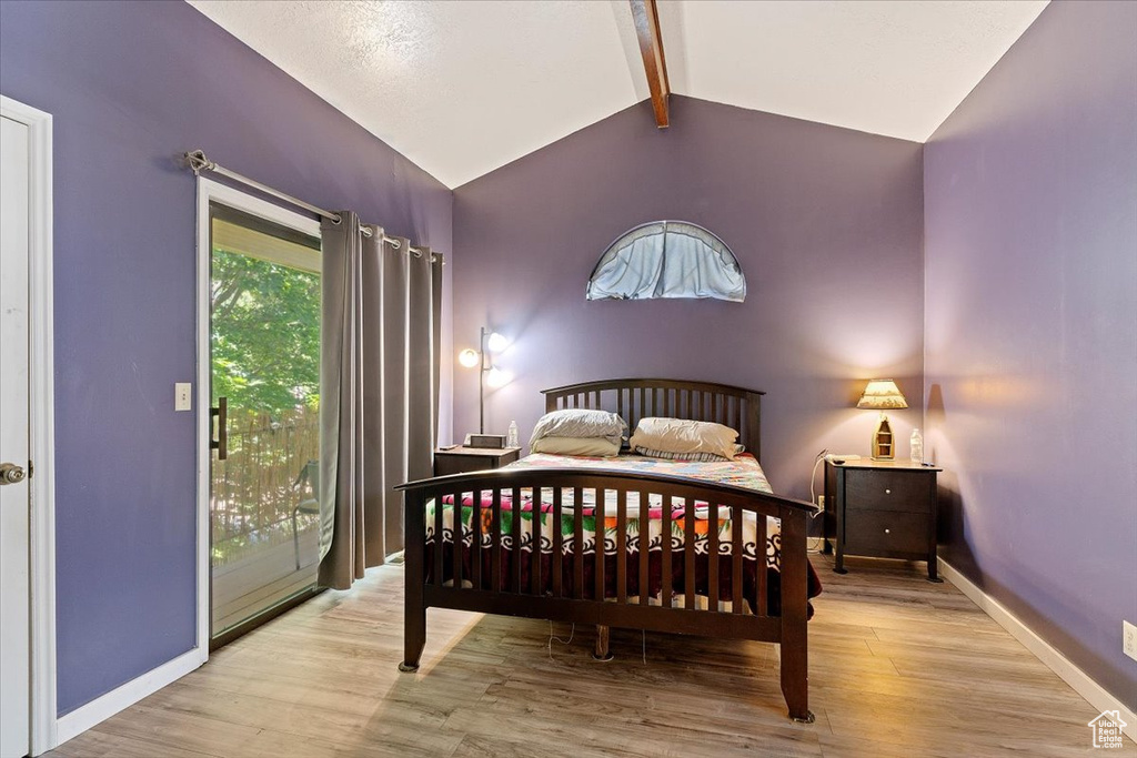 Bedroom featuring wood finished floors and access to exterior
