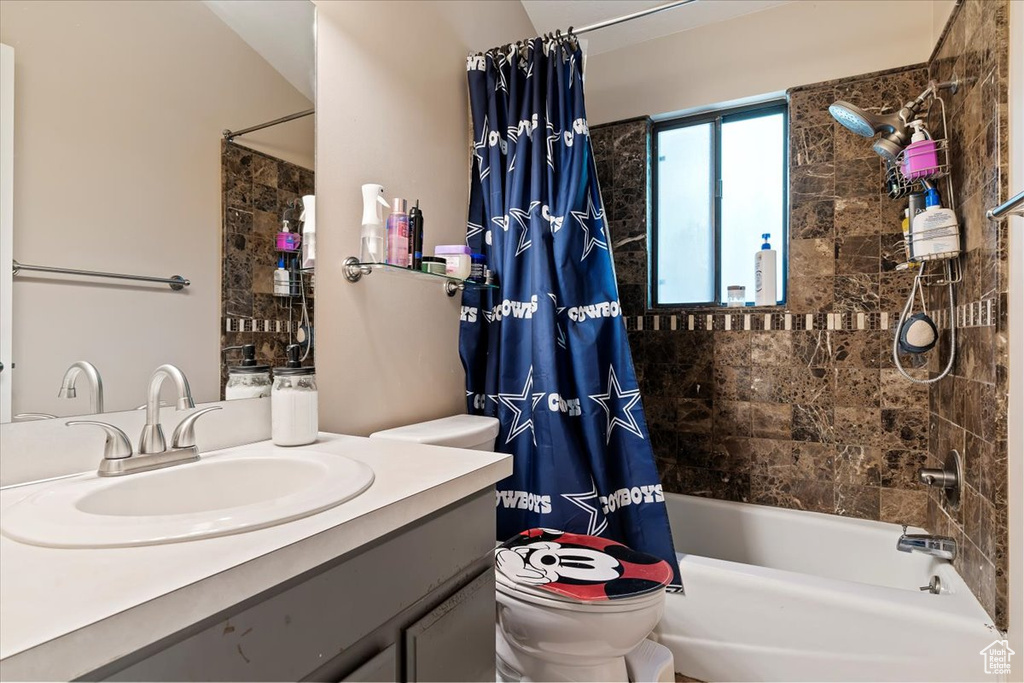Full bath with vanity and shower / tub combo with curtain