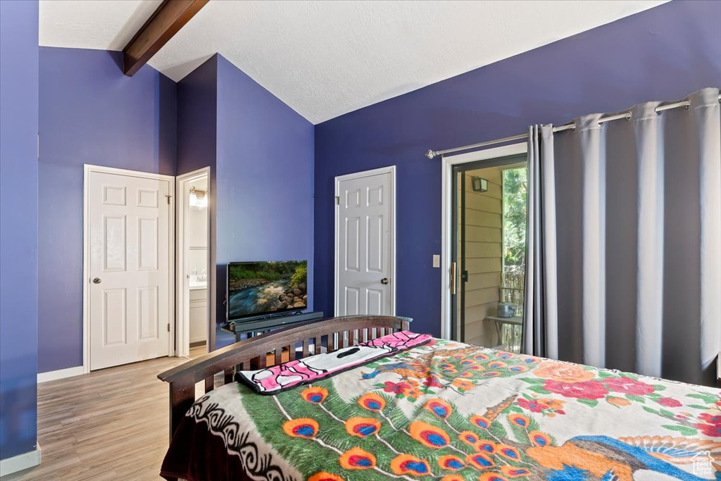 Bedroom featuring wood finished floors and baseboards