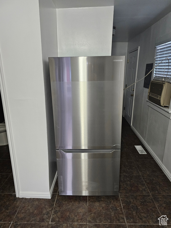 Kitchen view of freestanding refrigerator and cooling unit